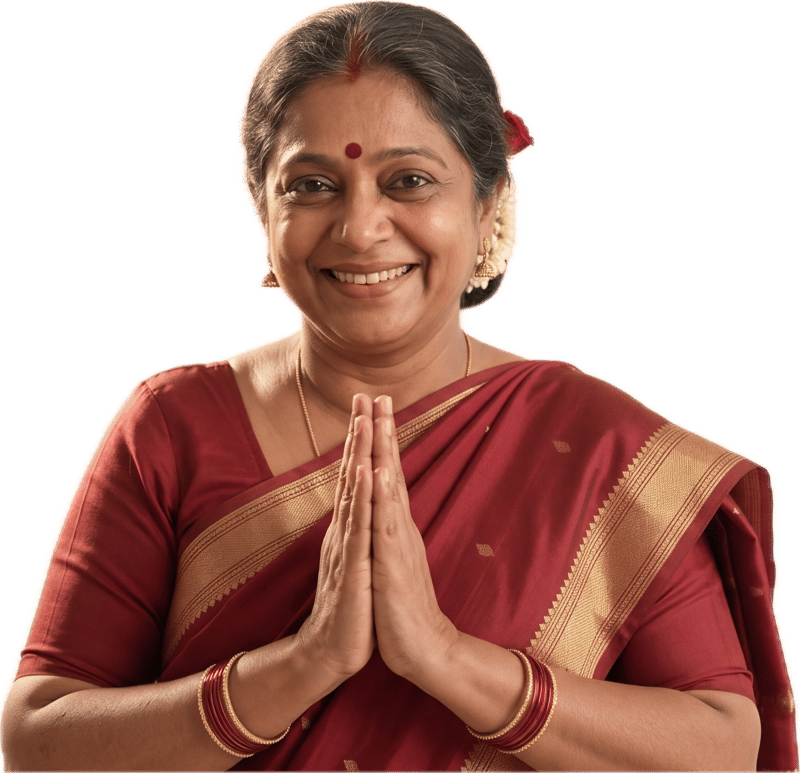 Pushpa Aunty smiling with her hands together in a namaste